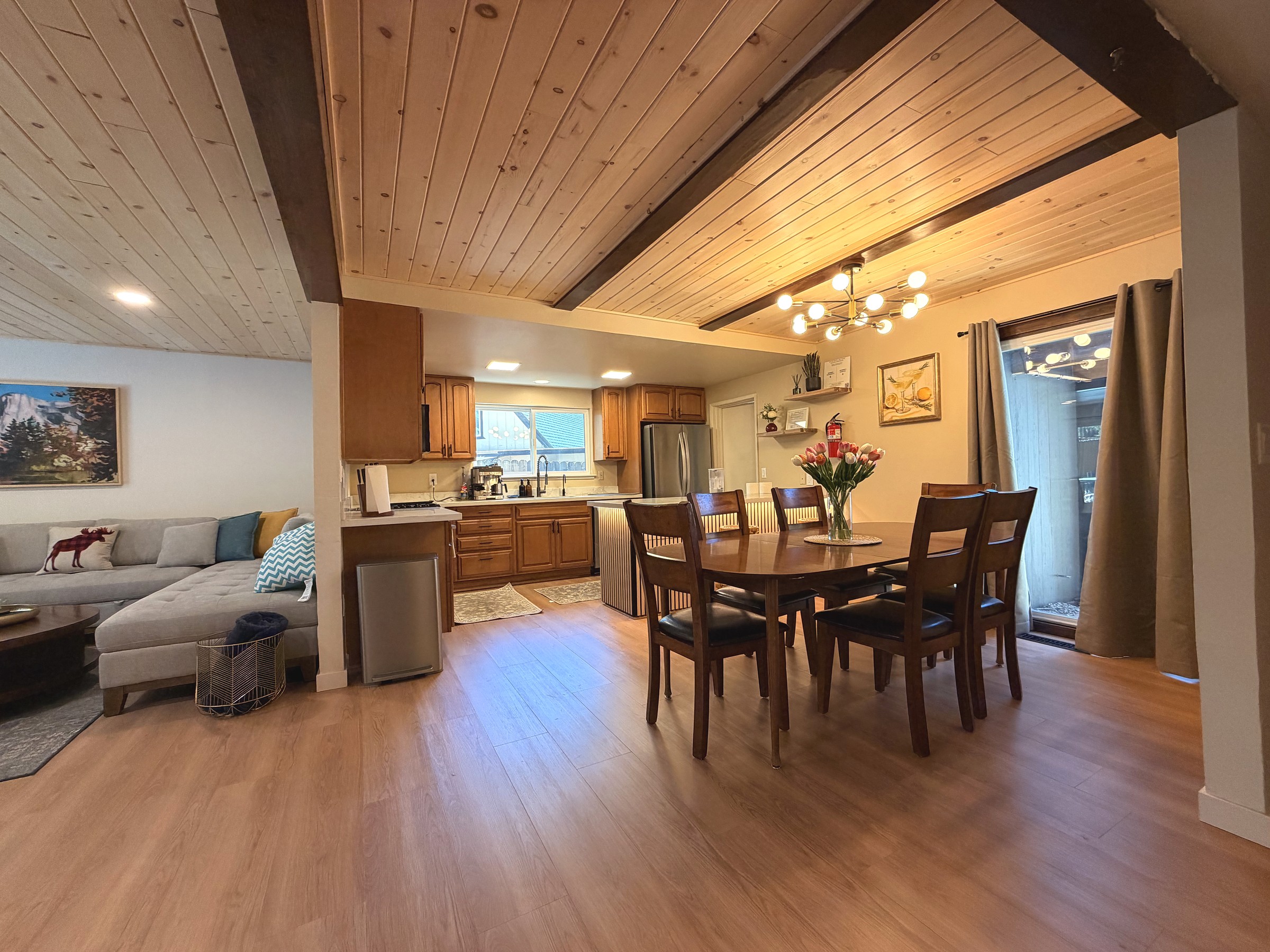 Great room with vaulted tongue-and-groove pine ceiling and sputnik chandelier